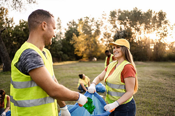 istock Volunteers collecting garbage in park are smiling and cooperating 2217297113