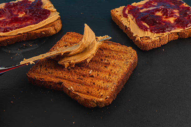 istock Making a classic peanut butter and jelly sandwich on toast 2217301062