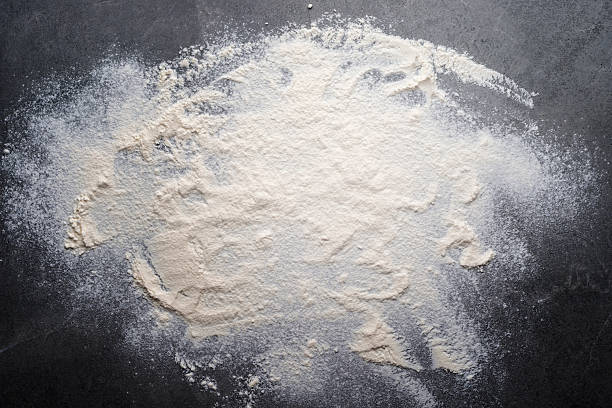 istock Flat lay cooking background of flour laying on slate board with copy-space. 2217304232