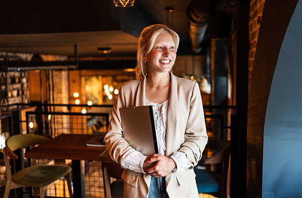istock Smiling businesswoman holding tablet in restaurant: ready for work 2217304590