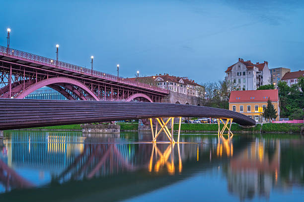 View from below on a beautiful blue arch bridge over a river in the middle of a winter day, Opole voivodeship.