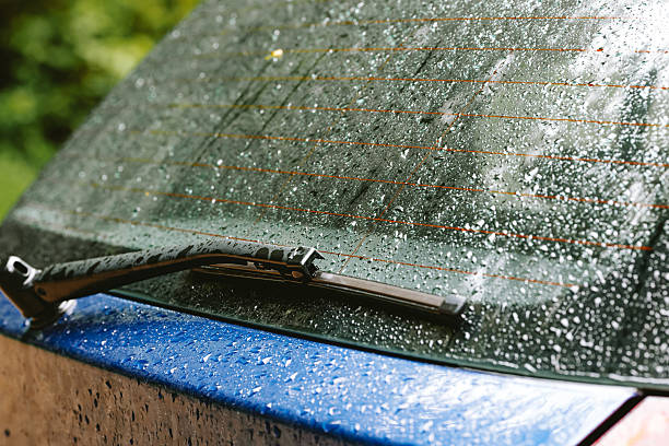 istock Dew, mist or condensation inside car rear windshield. Exterior shot, rainy summer day, close up, no people 2217305663