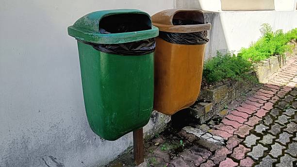 istock two orange and blue trash cans in the park 2217306517
