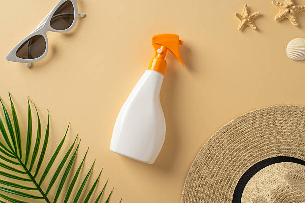 istock Summer-themed flat lay featuring beach essentials like suntan spray, sunglasses, hat, and starfish 2217311653