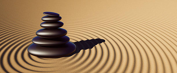 A serene and minimalist 3D render capturing the essence of tranquility and balance. A perfectly stacked cairn of smooth, black stones rests in a Japanese rock garden, with concentric circles raked into the surrounding sand. This powerful image symbolizes harmony, mindfulness, meditation, and stability. It is an ideal visual for wellness blogs, spa and health spa marketing, yoga studios, and any project related to relaxation, mental health, and finding inner peace. The simple yet profound composition evokes a sense of calm and focus.