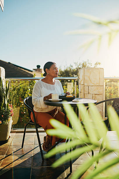 Serene Woman Enjoying Breakfast on Sunny Balcony