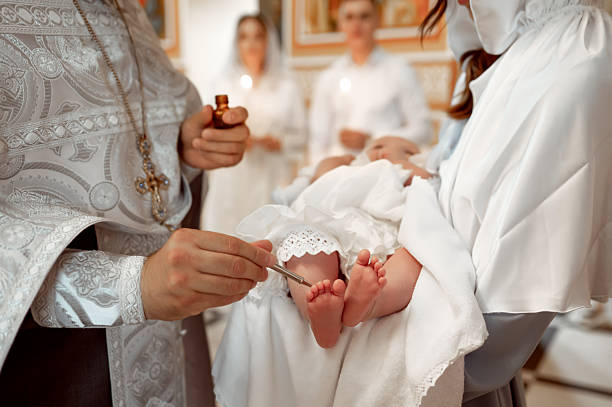 istock A priest anoints a baby's feet with oil during an Orthodox baptism 2217320855