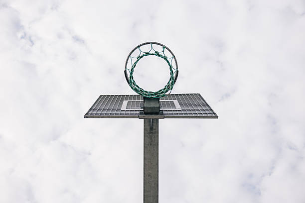 Basketball hoop standing tall against a cloudy sky