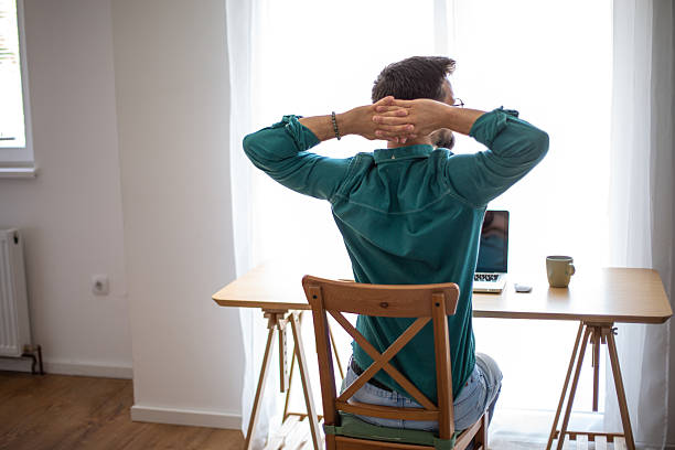 istock Freelancer stretching at home office desk after work 2217322726