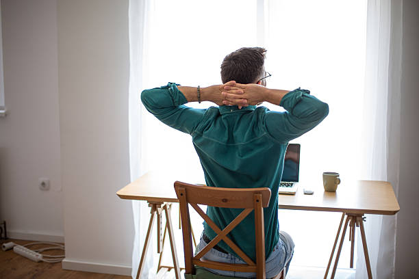 istock Freelancer relaxing at home office desk after work 2217322759