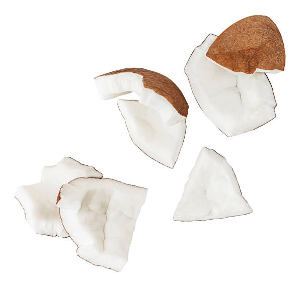 istock Isolated Coconut pieces falling on white background. Coconut explosion with broken pieces. Levitating coco nut slices  Top view. Flat lay. Pattern  2217323009