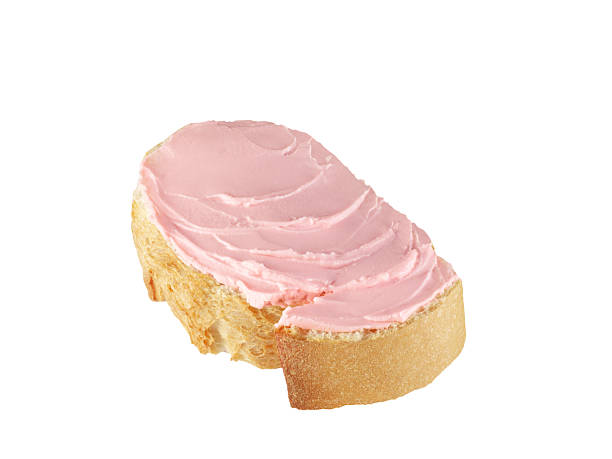Cream cheese with strawberry flavor spread on bread on white background with clipping path