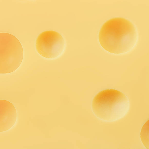 istock Cheese texture as a background Swiss holey maasdam cheese wallpaper. Pattern. High resolution image 2217323498