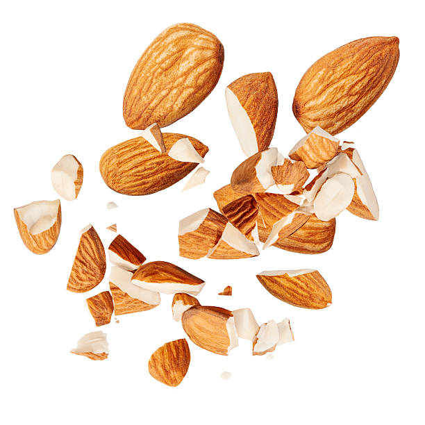 istock Isolated Almonds. levitating almond nuts on white background.  Falling crushed almonds nuts. Cracked Almonds is torn to pieces explosion 2217323671