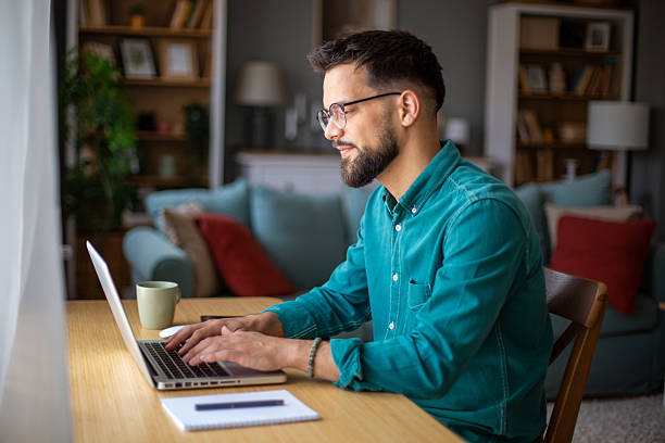 istock Young businessman working from home typing on laptop computer 2217323757