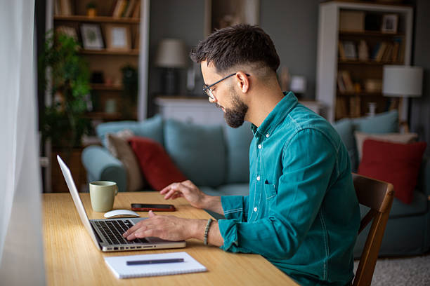 istock Focused young man working from home on laptop 2217323788