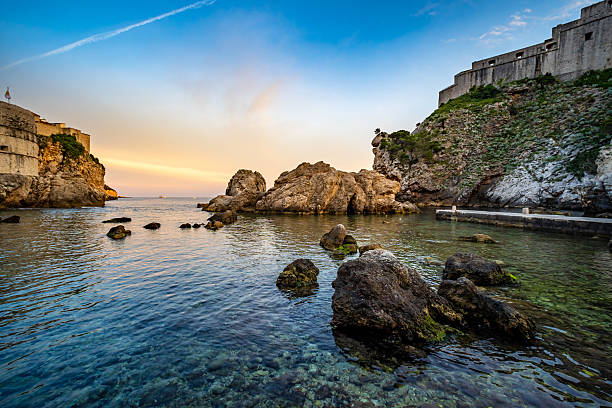 Sun sets over coastline outside old town Dubrovnik
