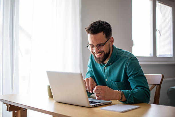 istock Young man working from home, feeling happy and successful 2217324433