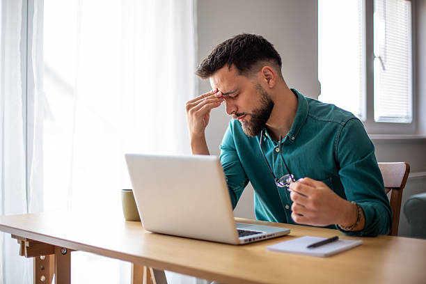 istock Stressed businessman having headache while working from home 2217325233