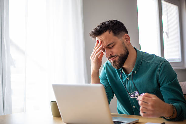 istock Stressed businessman having headache while working from home office 2217325267