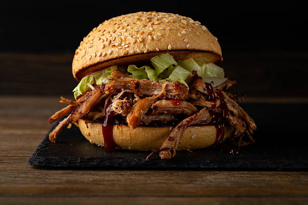 istock Close up of beef  burger on dark surface hero view 2217326806