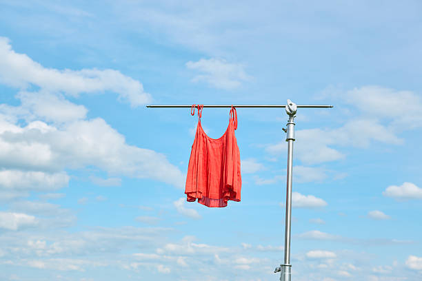 Colorful summer clothes on a spinning drying rack outside on a sunny day. Children clothes