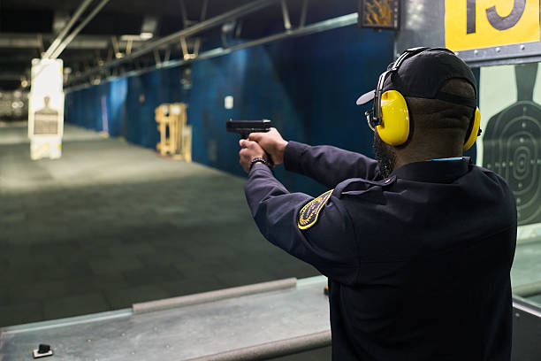 istock Practicing Shooting at Indoor Gun Range with Safety Gear 2217328023