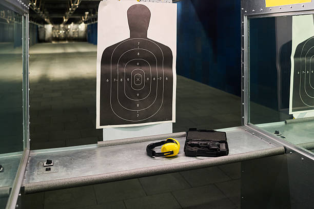istock Practicing Shooting at Indoor Firing Range with Safety Gear 2217328102