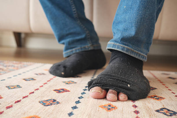istock men feet with dirty socks while sitting on sofa 2217329559