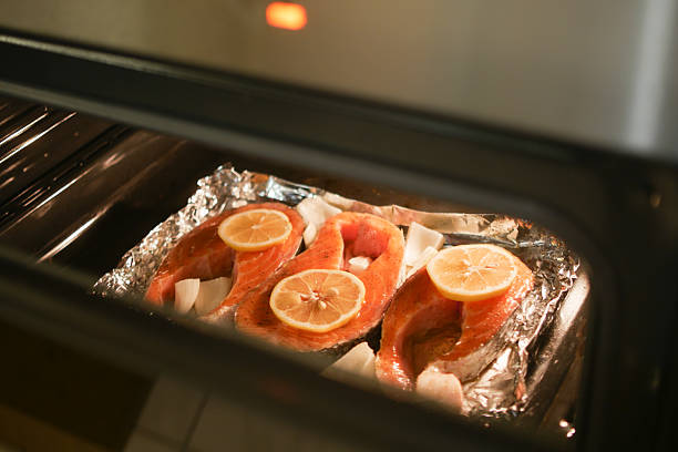 istock Salmon fillets baking with lemon slices in an oven 2217329823