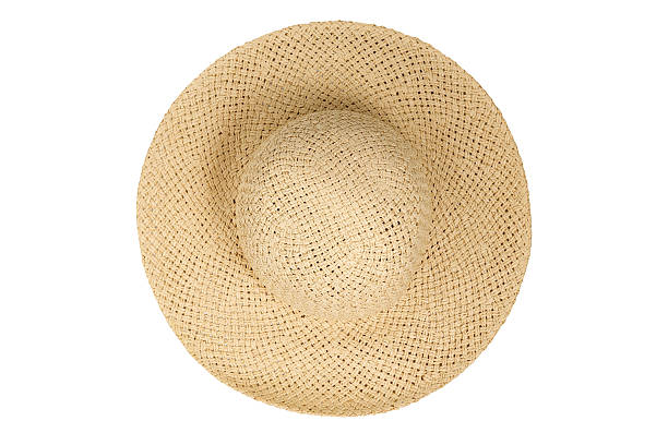 istock Straw hat top view isolated white background. Beach hat flat lay, with clipping path as design banner studio shot with sunlight. Summer travel cap for beach holiday on Vacation 2217331531