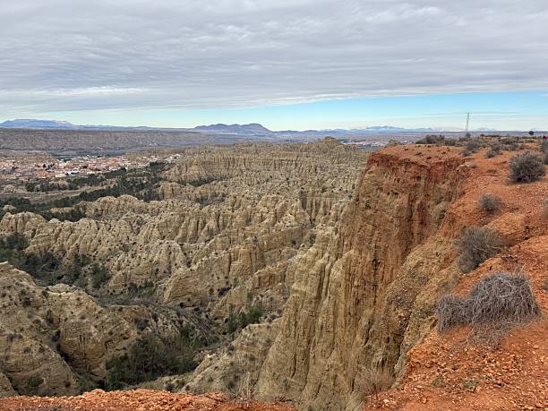 istock Rugged desert terrain with rock formations and distant mountains 2217332656