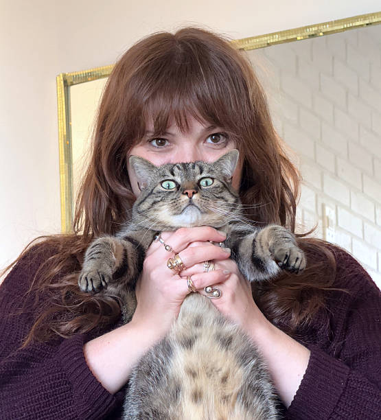 istock Beautiful young woman with her cat 2217332709