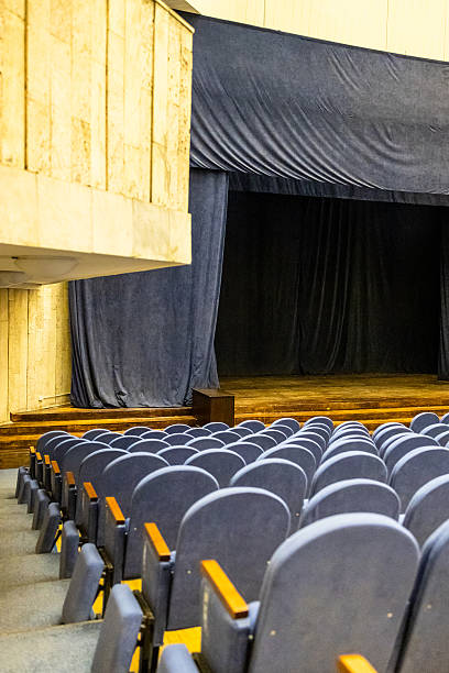 istock gray soft seats and scene in auditorium 2217333677