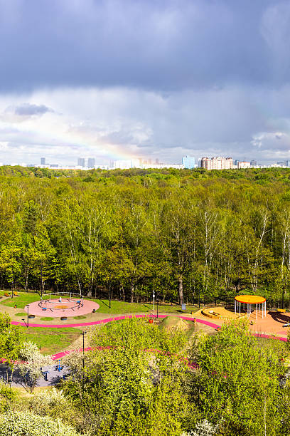 istock sunlit playground and park after rain with rainbow 2217333713