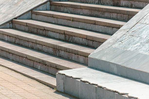istock A staircase with a white railing and a grey stone wall 2217334029