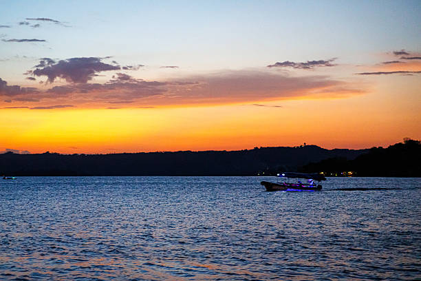 istock Boat at sunset on Flores Island, Guatemala 2217334373