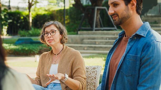istock Diverse group people participating in outdoor community therapy session focused on mental health awareness and support sharing advice to promote empathy togetherness. Mental health concept. 2217337638