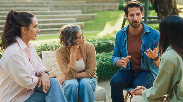 istock Diverse group people participating in outdoor community therapy session focused on mental health awareness and support sharing advice to promote empathy togetherness. Mental health concept. 2217338053