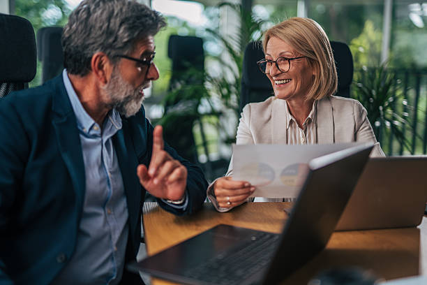 istock Senior businesspeople discussing charts in modern office 2217338840