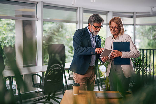 istock Senior business people using digital tablet in modern office 2217339264