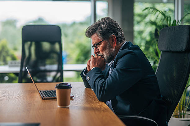istock Worried senior businessman sitting at his desk and thinking about a solution 2217339529