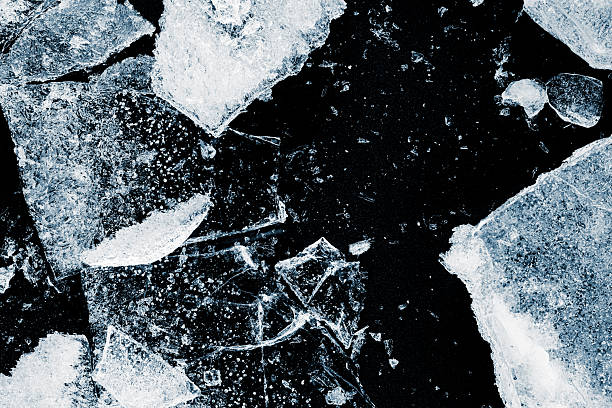 istock Broken textured ice. Crushed natural textured ice on a black background, close-up. 2217341348