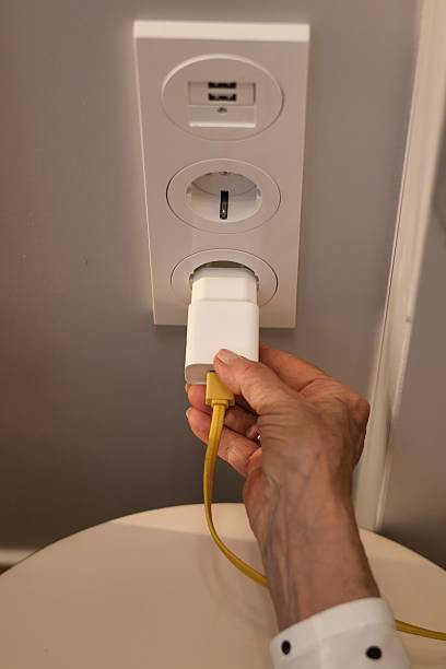 istock Rising electricity prices; Close-up of a hand inserting a plug into a socket 2217341629