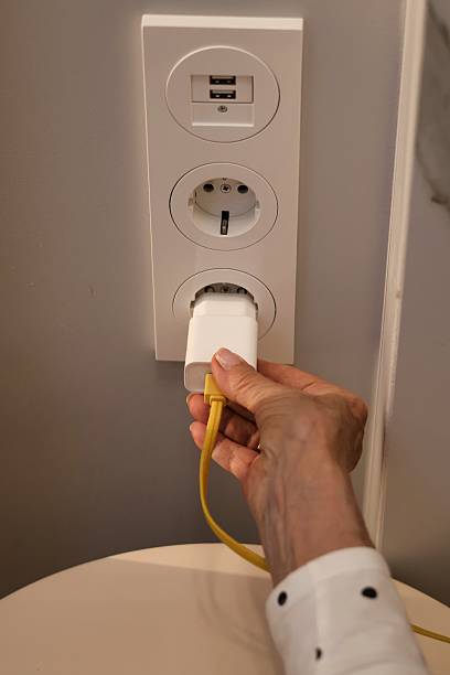 istock Rising electricity prices; Close-up of a hand inserting a plug into a socket 2217341663