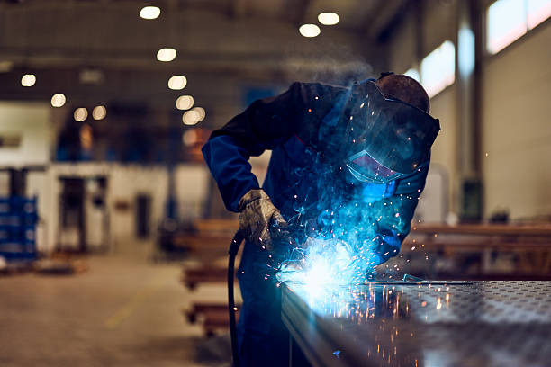 istock Industrial Welder Working With Bright Sparks in a Modern Factory Setting 2217345060