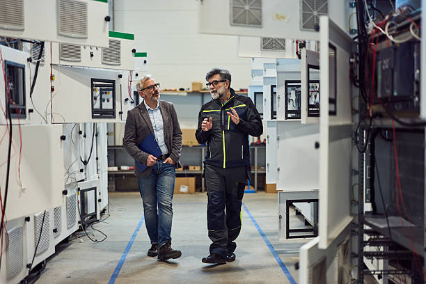 istock Professional Technicians Inspecting Laboratory Equipment in a High-Tech Manufacturing Facility 2217345092