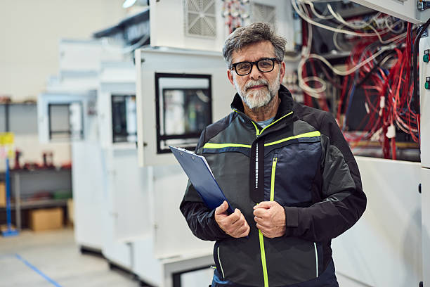 istock Experienced Technician With Clipboard Standing in Modern Industrial Facility 2217345106