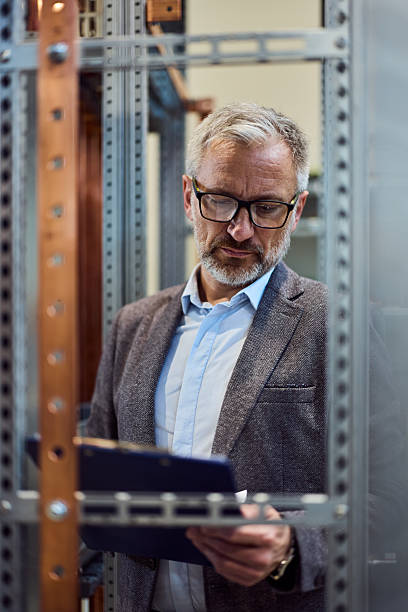 istock Professional Man Working in a Technology Environment with Documents Near Electrical Equipment 2217345108