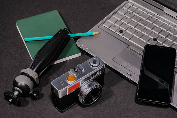 istock Creative workspace with a camera, tripod, notebook, pencil, laptop, and smartphone in overhead view. 2217345329